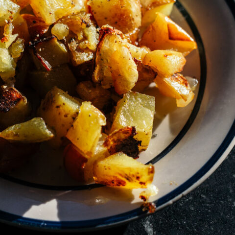 These roasted potatoes with spiced apples and onions are an easy, flexible recipe that can be tweaked for anyone's tastes. Especially good for cooking on a budget, this is a great way to use up your sturdy produce at the end of the week.
