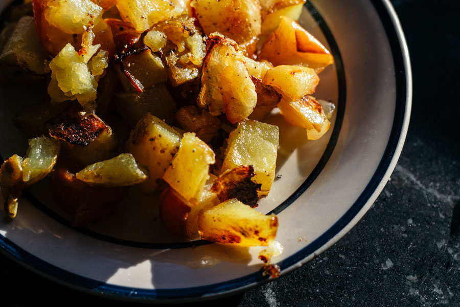 These roasted potatoes with spiced apples and onions are an easy, flexible recipe that can be tweaked for anyone's tastes. Especially good for cooking on a budget, this is a great way to use up your sturdy produce at the end of the week.