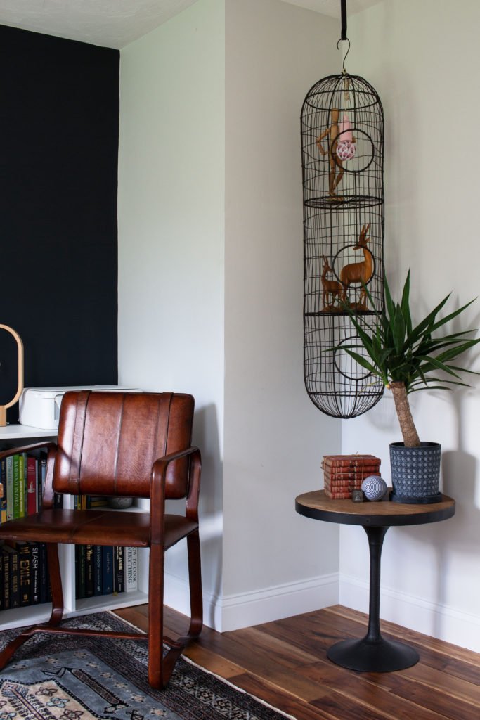 Graphic Home Office: One Room Challenge. A super cool thrifted cage fills the awkward vertical space by the desk.