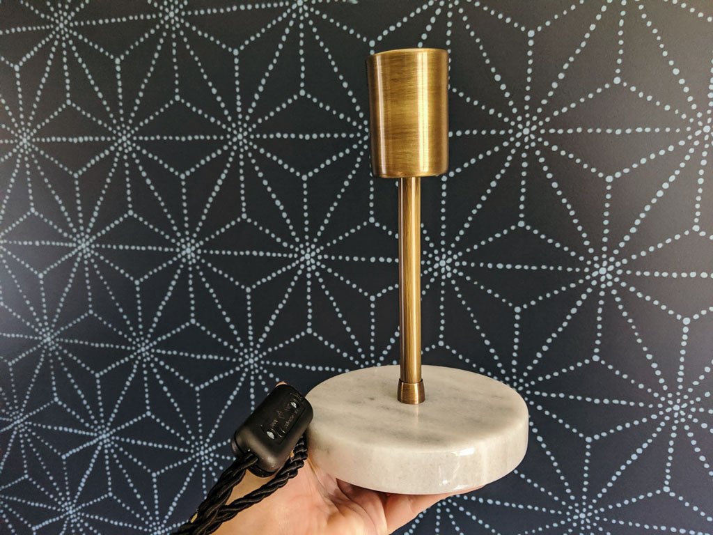 This brass and marble lamp is perfect against the blue stenciled accent wall.