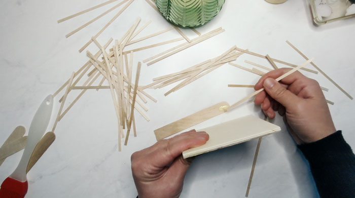 Glue coffee stir sticks around the edge of your wood mosaic coaster