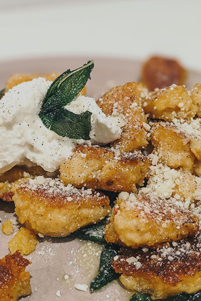 Delicious crispy sweet potato gnocchi with bacon and fried sage