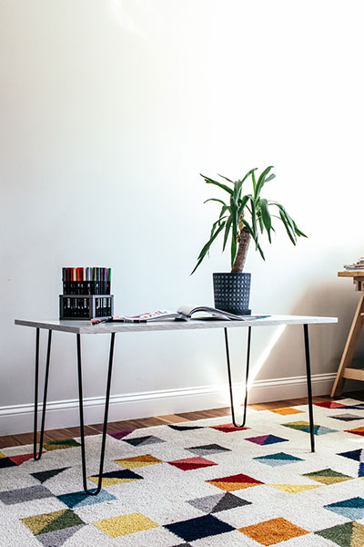 Learn to make a DIY hairpin leg coffee table by installing hairpin legs to a piece of laminate. Plus, learn the three biggest mistakes to avoid and the answers to all of your most frequently asked questions about making DIY furniture with hairpin legs.