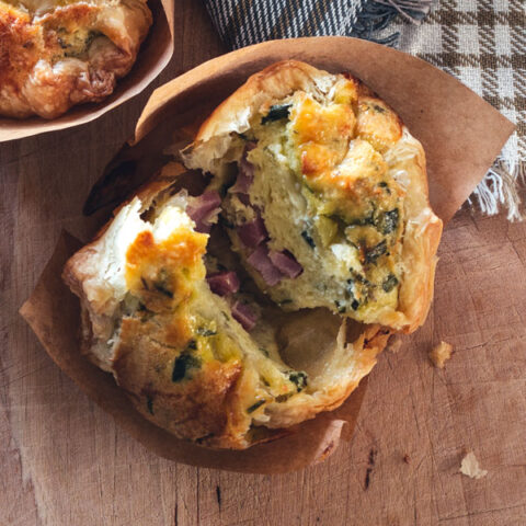 This recipe for ham and artichoke souffle muffins is deceptively easy. Use up leftover ham, blend eggs with premade artichoke dip, wrap in flaky layers of puff pastry to make an impressive weeknight meal. These tiny egg souffles also freeze and reheat beautifully.