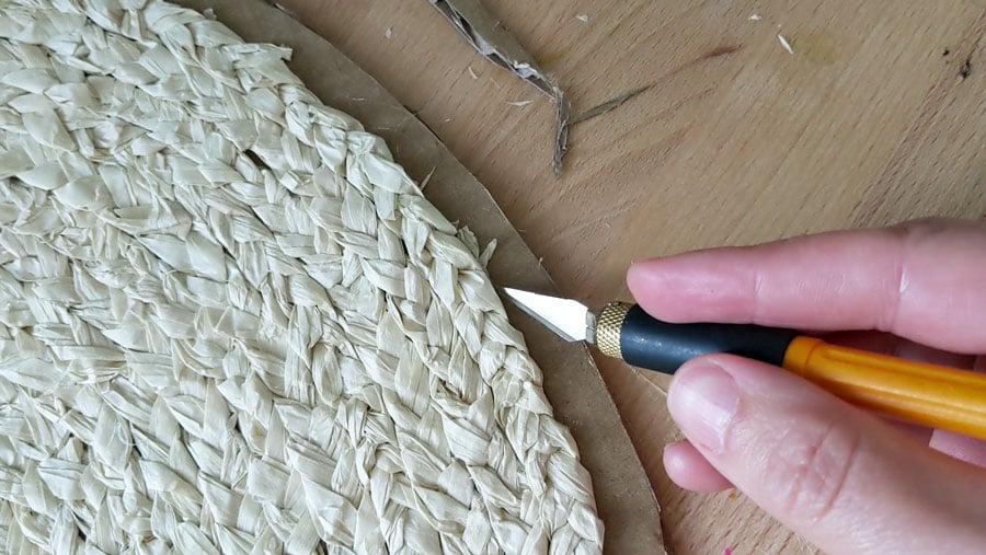 Trim the excess cardboard from the edges of your DIY seagrass placemat