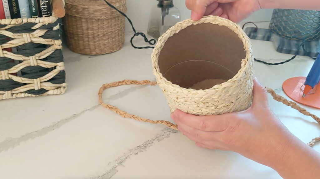 Finish the rim of your basket with a row of raffia braid on the inside lip of the container.
