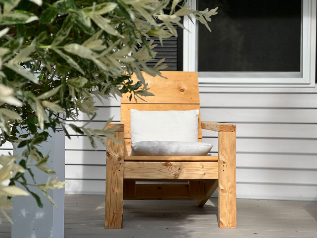 Adirondack chair with outdoor cushions on front porch.