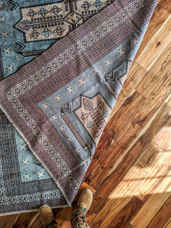 Vintage turkish rug on acacia wood floor