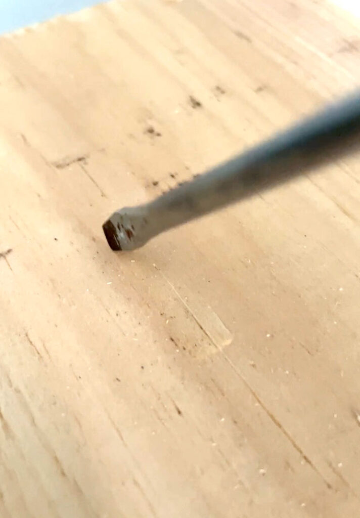 Use a screwdriver to gouge the wood