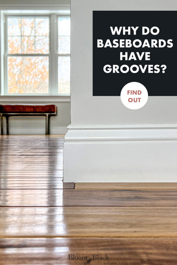 Close up of a baseboard at the corner of a white hall with a leather bench in the background. The text on the image says, "Why do baseboards have grooves? Find out."