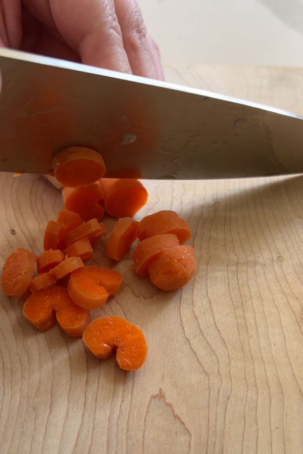 Chopping carrots.