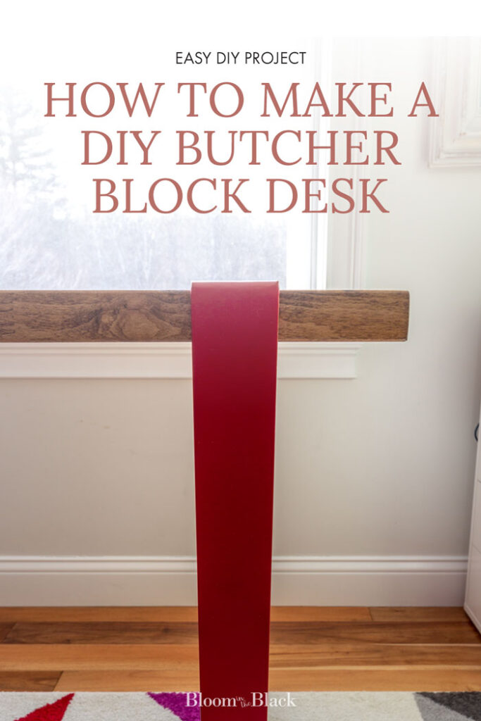 Close-up of a butcher block desk with red legs. The text reads, "How to build a DIY Butcher Black Desk"