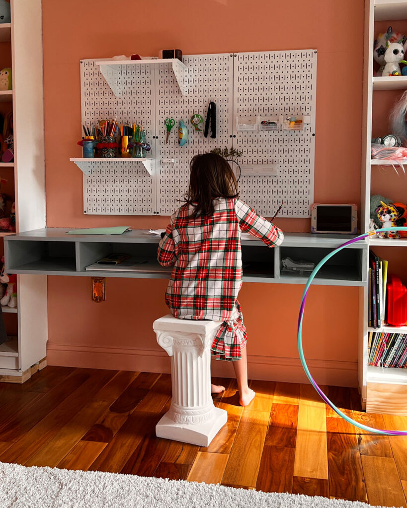 Child working at a blue built-in desk