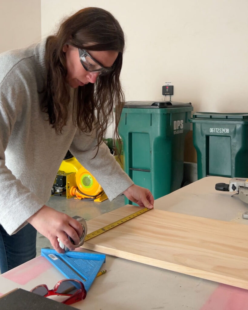 Woman measuring wood.