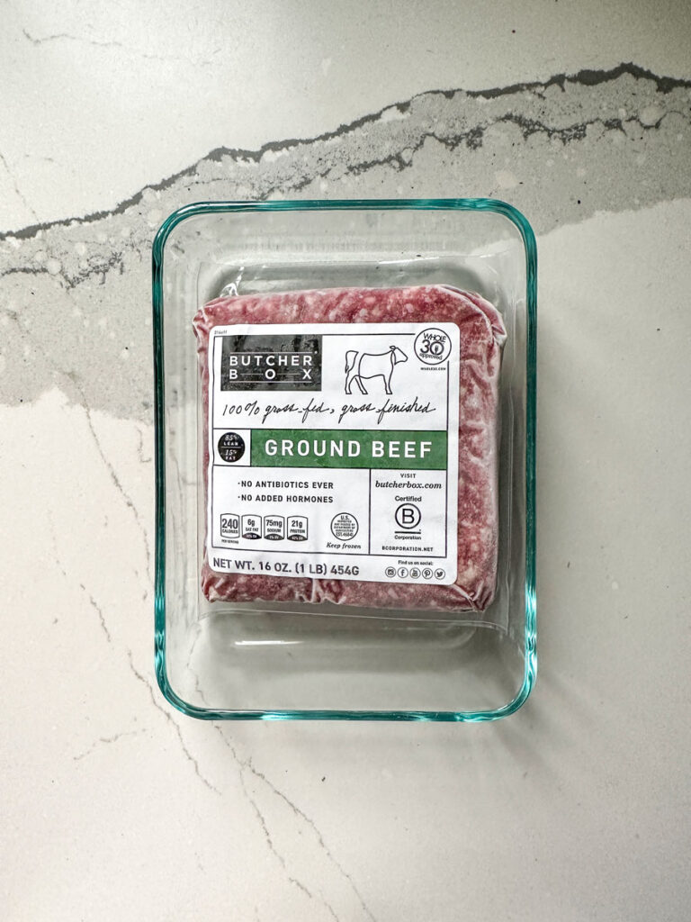 Butcher Box ground beef defrosting on the counter.